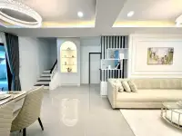 3 Bedroom House for Sale in Na Kluea living room with staircase, display shelving, and beige sofa
