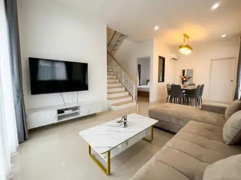 4 Bedroom House for Rent in Central Pattaya open-plan living room with staircase and dining area