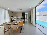 3 Bedroom House for Sale in Pong open-plan dining and kitchen area with pool view through glass doors