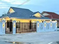 3 Bedroom House for Sale Pattaya twilight view of gabled roof house with black iron gate
