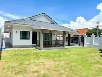 3 Bedroom House for Sale Pattaya daytime exterior with covered porch and green lawn