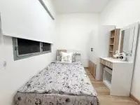 2 Bedroom Condo for Sale at Eua Arthorn Naklua second bedroom with single bed, white wardrobe, and desk mirror