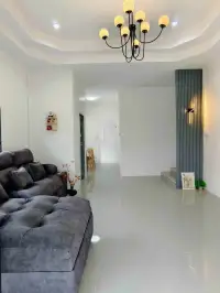 3 Bedroom House for Sale in Pattaya - open living area with hallway view and modern wall sconce lighting