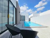 3 Bedroom House for Sale in Pong poolside patio with lounge chairs and sliding glass doors