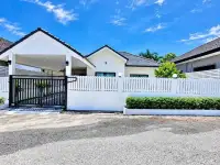 3 Bedroom House for Sale in Pattaya, white bungalow exterior with gated entrance and black fence