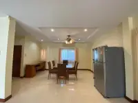 3 Bedroom House for Sale in Pattaya - open dining area with wooden table and stainless steel fridge