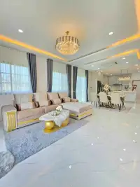 4 Bedroom House for Sale in Huai Yai open-plan living room with crystal chandelier and sectional sofa