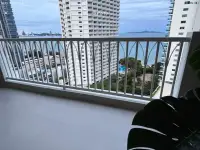 Studio Condo for Sale at Wongamat Garden Beach Resort balcony view of sea, pool, and Pattaya skyline