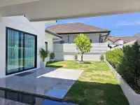 3 Bedroom House for Sale in Pattaya, private garden patio with glass sliding doors and green lawn