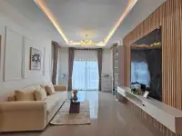 3 Bedroom House for Sale in Pattaya, living room with chandelier, curtains, and wood-paneled TV wall