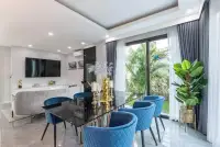 5 Bedroom House for Sale open-plan dining area with blue velvet chairs and garden view