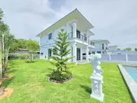 4 Bedroom House for Sale in Huai Yai front garden view with cherub statue and manicured lawn