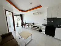 1 Bedroom Condo for Sale at C View Residence 2 open-plan living area with kitchen counter and dining space
