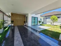 3 Bedroom House for Sale in Pattaya, covered carport with marble tile flooring and wood accent wall