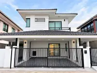 3 Bedroom House for Sale in Na Kluea modern two-story white exterior with black gate and carport