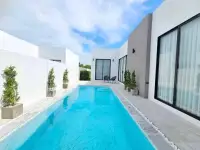 3 Bedroom House for Sale in Pong private pool with white modern villa facade and potted plants