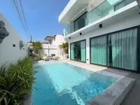 5 Bedroom House for Sale private swimming pool and sun loungers beside glass-walled living area