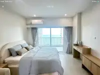 Studio Condo for Sale at Wongamat Garden Beach Resort bedroom with ocean view balcony and wooden desk