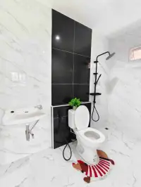 3 Bedroom House for Sale in Pattaya - marble-tiled bathroom with black accent wall and rainfall shower