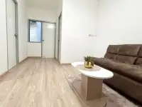 2 Bedroom Condo for Sale at Eua Arthorn Naklua open living area with sofa, coffee table, and view toward entrance hallway