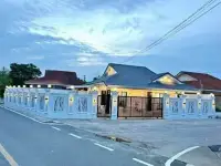 3 Bedroom House for Sale Pattaya evening exterior view with white perimeter wall and gated entrance