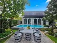 4 Bedroom House for Sale in Mabprachan poolside patio with barrel-style chairs and solar panel roof