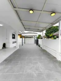 3 Bedroom House for Sale in Pattaya - covered driveway and carport leading to gated entrance