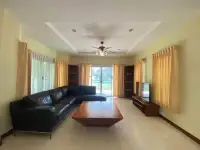 3 Bedroom House for Sale in Pattaya - spacious living room with black leather sofa and garden view