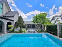 4 Bedroom House for Sale in Mabprachan backyard pool and outdoor dining area under blue sky