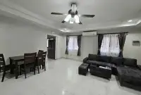 3 Bedroom House for Rent at Pattaya Lagoon Village living and dining space with ceiling fan and curtained windows