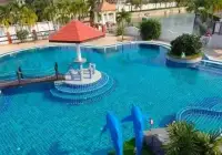 3 Bedroom House for Rent at Pattaya Lagoon Village community swimming pool with dolphin statues and lagoon view