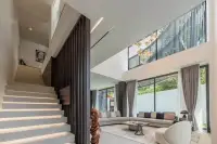 6 Bedroom House for Sale in Pratumnak Hill modern staircase with floating steps beside double-height living room