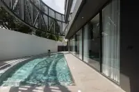 6 Bedroom House for Sale in Pratumnak Hill outdoor lap pool beside glass walled living area