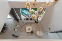 6 Bedroom House for Sale in Pratumnak Hill overhead view of living room with hanging pendant lights and pool access