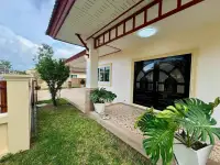 3 Bedroom House for Sale in Pattaya, side entrance with black decorative double doors and plants