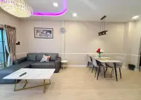 3 Bedroom Townhouse for Rent in Central Pattaya living room with gray sofa, dining table, and crystal chandelier