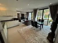 2 Bedroom Townhouse for Sale open kitchen and lounge area with view to pool through sliding doors