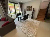 2 Bedroom Townhouse for Sale living room with staircase, decorative statues and garden view