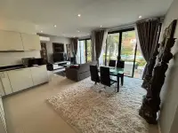 2 Bedroom Townhouse for Sale living room with shag rug, dining set and glass doors to garden