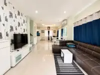 3 Bedroom House for Sale in East Pattaya spacious living area with brown leather sofa and dining space