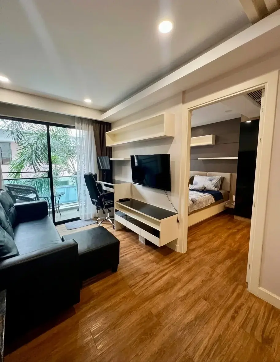 1 Bedroom Condo for Sale at Dusit Grand Park 1 outdoor swimming pool with footbridge and tropical landscaping