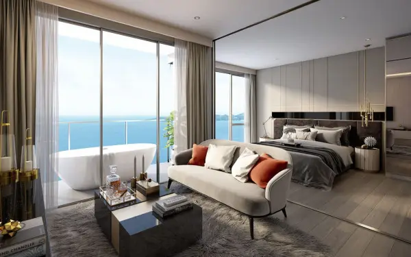 1 Bedroom Condo for Sale at The Panora Pattaya bedroom with freestanding tub, sea view windows, and mirrored accent wall