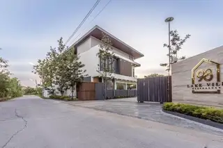 98 Lakeville Mabprachan modern building exterior with entrance gate and property sign at dusk.