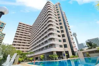 Kieng Talay tall condo building exterior with balconies, glass elevator, swimming pool, and Pattaya Tower in background.