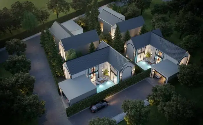 Celestial Villa Pattaya: Modern house exterior with gabled roof, illuminated facade, and attached garage at dusk.