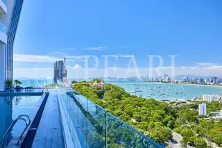 The Vision: Infinity pool overlooking Pattaya Bay, lush green hills, and city skyline under a clear blue sky.