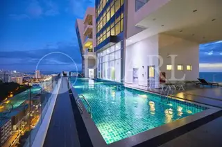 The Vision: Rooftop swimming pool at night, with city lights in the background and a dark blue sky.