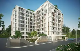 Siam Oriental Dream: Modern white and brown condominium building with multiple balconies, lush landscaping, and a street view.