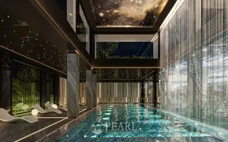 Embassy Pattaya indoor swimming pool with starry ceiling, lounge chairs, and waterfall feature.