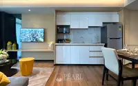 2 Bedroom Condo for Sale at Beverly Mountain Bay Pattaya integrated kitchen with white gloss cabinets, TV wall, and dining area